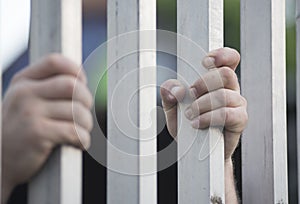 prisoner at the window of a prison cell