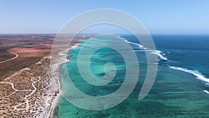 Pristine Coral Reef in turquoise water seen from above. Top down aerial footage. Ningaloo Reef, Australian tourism.