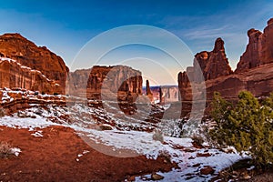 Pristine winter snowy view of `Park Avenue` in Arches National Park at sunrise in Moab Utah