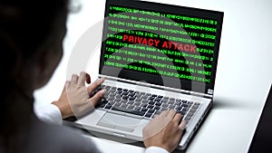 Privacy attack on laptop computer, woman working in office, cybercrime, close up