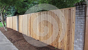 Privacy cedar fence with brick accents showing horizontal