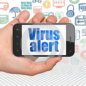 Privacy concept: Hand Holding Smartphone with Virus Alert on display