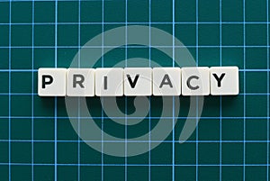 Privacy word made of square letter word on green background.