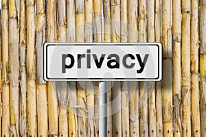 Privacy written on road sign against a bamboo fence - concept image