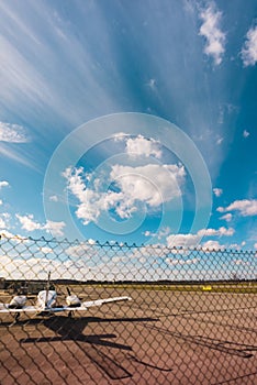 Privat Airplane on the road. Dramatic blue sky with clouds