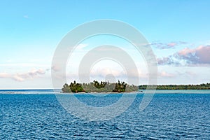 Privat island with beautiful beach in greenblue water ofa lagoon of Bora Bora. Perfect holiday destination, French Polynesi