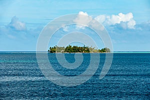 Privat island with beautiful beach in blue water ofa lagoon of Bora Bora. Perfect holiday destination, French Polynesia