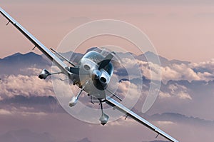 Privat light airplane or aircraft fly on mountain background. VIP travel concept