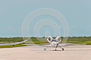 Private aircraft, taxing on a tropical airport photo