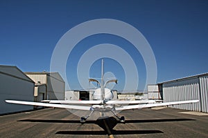 Private airplane between hangars