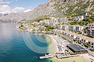 Private beach in front of the luxury villas of the Huma Kotor Bay hotel. Dobrota, Montenegro. Drone