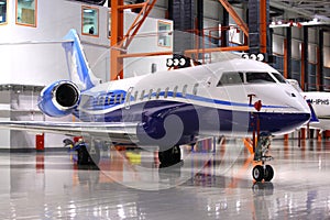 Private Bombardier Global 5000 OY-SGC standing in a hangar at Sheremetyevo international airport.