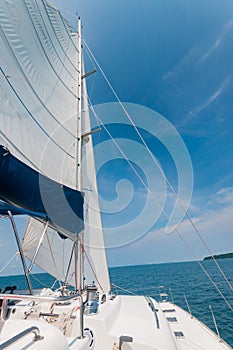 Private catamaran boat floating near the island. Luxury Lifesty