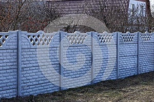 private concrete gray wall fence on a rural street