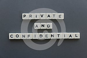 Private and confidential word made of square letter word on grey background.