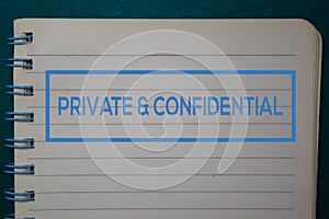 Private & Confidential write on a book isolated on green background