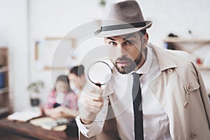 Private detective agency. Man is posing with magnifying glass, woman is holding her daughter.