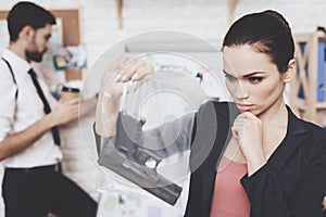 Private detective agency. Woman is posing with gun, man is looking at clues map.