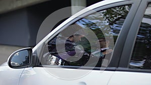 Private detective spying on famous couple from his car, making photos, privacy
