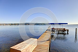 Private dock with jet ski lifts and covered boat lift, Lake Washington.