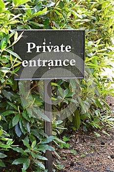 Private entrance sign in woodland setting.