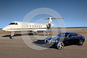 Private Gulfstream G550 executive airplane with Rolls Royce Wraith luxury car shown together at Sheremetyevo international airport