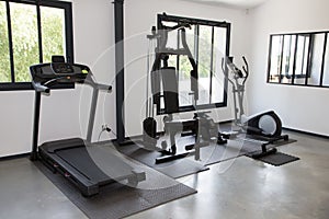 Private gym at home interior with different sport exercise equipment