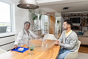 Private home doctor office female healthcare medical worker work with sick male patient. Ill young man talking with medic health