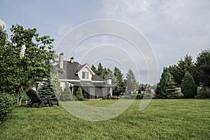 Private house and its garden under beautiful sky