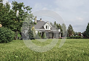 Private house and its garden under beautiful sky