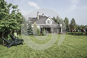 Private house and its garden under beautiful sky