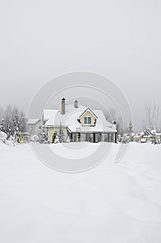 A private house and its garden under snow in winter
