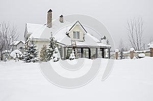 A private house and its garden under snow in winter