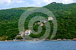 Private houses along the coastline in the mountains