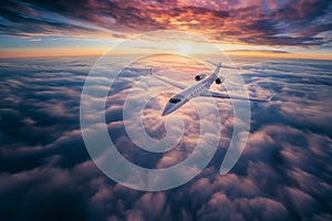 Private jet airplane flying above clouds in sunset