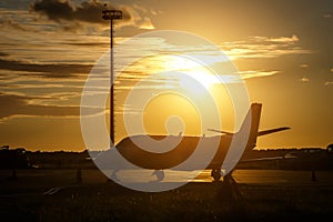 Private jet in the airport at sunset