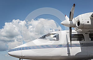 Private jet exterior against the blue sky. Airplane cockpit