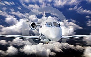 Private jet flying under cloudy blue sky