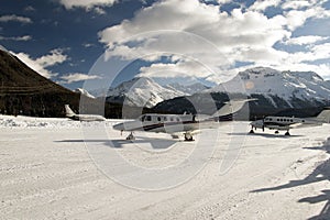 Private jets and an jet airplane taking off in the airport of St Moritz Switzerland in winter