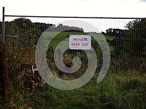 Private keep out sign on fence zoom