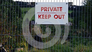 Private keep out sign on fence zoom