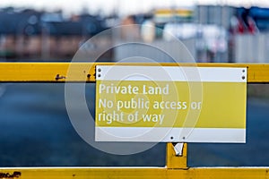 Private land no public access or right of way yellow sign on entrance gate