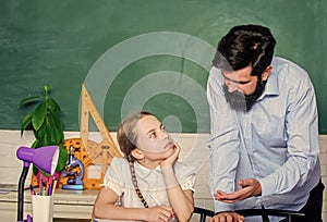 Private lesson. Homeschooling with father. Pedagogue skills. School teacher and schoolgirl. Man bearded pedagogue