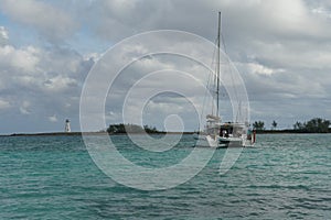 Private luxury catamaran anchored near entrance to Nassau harbor in the Bahamas.