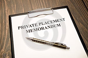 Private placement memorandum document with pen on desk