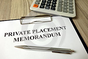 Private placement memorandum with pen and calculator