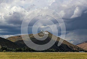 Private Plane landing in small airfield by farmland with mountains in distance on stormy day near Ketchum and Sun Valley Idaho photo