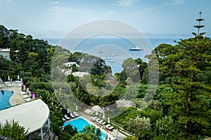 Private pools overlook luxury yachts on the Mediterranean Sea on the beautiful island of Capri in southern Italy