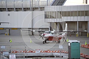 Private prop plane waits beside airport for passengers to arrive