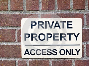 private property access only black and white sign on brick wall